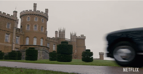 A Netflix Ad Shows A Castle And A Car Driving By GIF