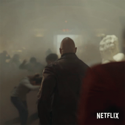 A Netflix Ad Shows A Man In A Crowd Of People GIF