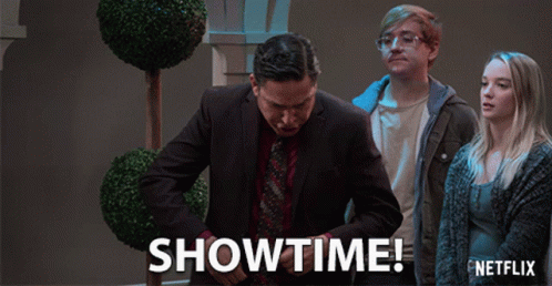 A Netflix Ad Shows A Man In A Suit And Tie Standing Next To A Woman GIF
