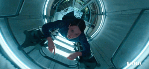 A Netflix Ad Shows A Woman Floating Through A Tunnel GIF