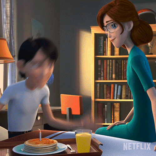 A Netflix Ad Shows A Woman Sitting At A Table With A Tray Of Pancakes GIF