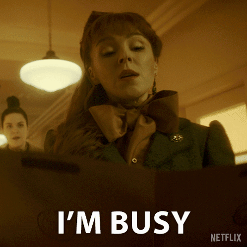 A Netflix Ad Shows A Woman With A Bow Tie And The Words I 'M Busy GIF