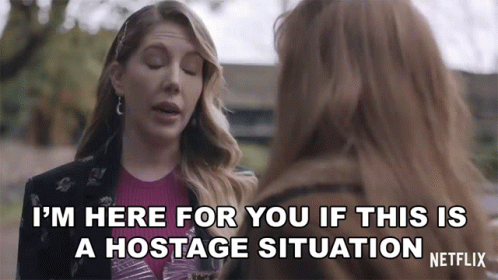 A Netflix Ad Shows Two Women Talking And One Says I 'M Here For You If This Is A Hostage Situation GIF