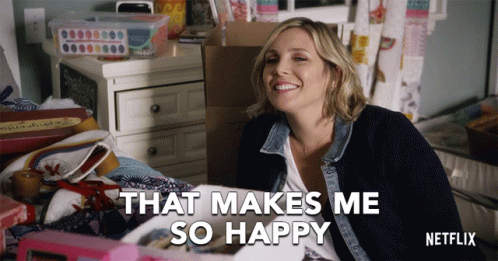 A Netflix Advertisement Shows A Woman Sitting On A Bed Smiling And Saying That Makes Me So Happy GIF