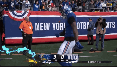 A New York Giants Football Player Runs On The Field GIF