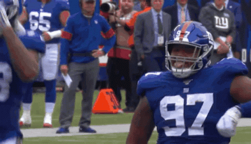 A New York Giants Football Player Wearing A Number 97 Jersey GIF