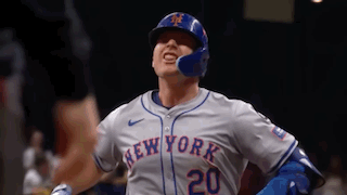 a new york mets baseball player is wearing a helmet and a jersey .