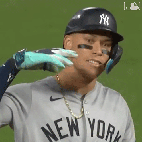 A New York Yankees Baseball Player Is Being Touched By Another Player 'S Glove . GIF