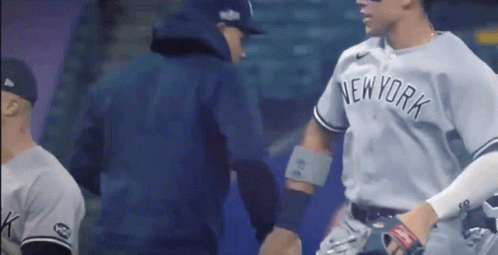 A New York Yankees Baseball Player Shakes Hands With A Coach GIF