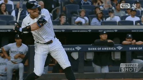 A New York Yankees Baseball Player Swings His Bat At A Ball GIF