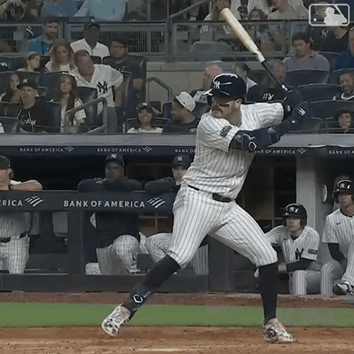 A New York Yankees Baseball Player Swings His Bat At The Ball GIF