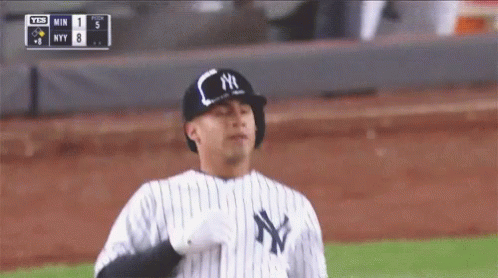 A New York Yankees Baseball Player Wearing A Black And White Striped Uniform GIF