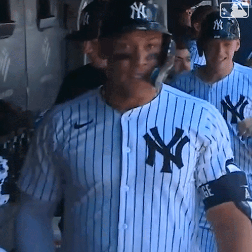 A New York Yankees Baseball Player Wearing A Blue And White Striped Shirt GIF