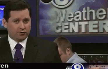 A News Anchor Stands In Front Of The Weather Center GIF