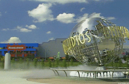 A Nickelodeon Building With A Globe In Front GIF