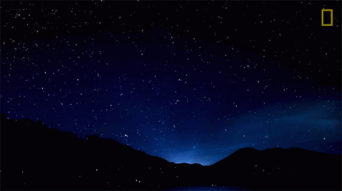 A Night Sky With A Shooting Star And A National Geographic Logo GIF