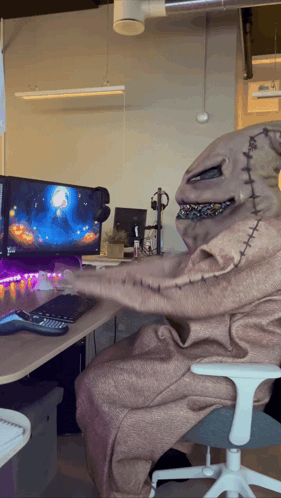 A Nightmare Before Christmas Character Is Sitting In Front Of A Computer Screen GIF