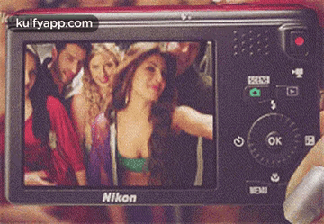 A Nikon Camera Shows A Group Of People Posing For A Picture GIF