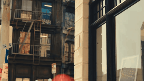 A No Parking Sign Is On The Side Of A Brick Building GIF