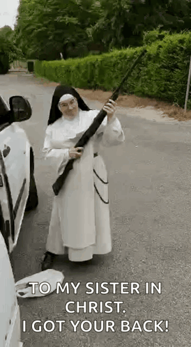 A Nun Is Holding A Gun In Front Of A Car And Says `` To My Sister In Christ , I Got Your Back ! '' GIF