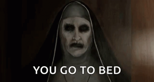 A Nun With Glowing Eyes And A Mustache Is Saying You Go To Bed . GIF