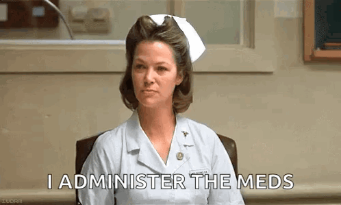 A Nurse Is Sitting In A Chair In A Hospital And Says `` I Administer The Meds '' . GIF