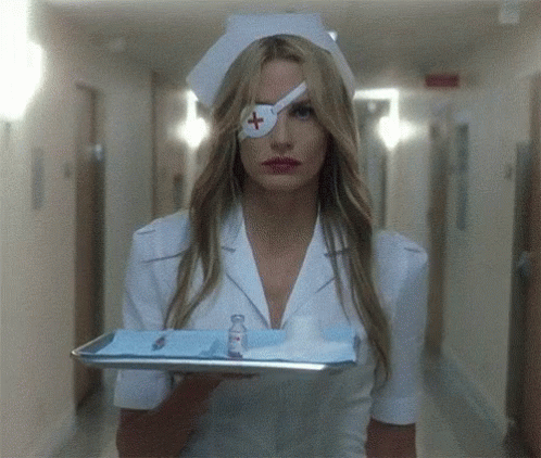 A Nurse With A Bandage On Her Eye Is Holding A Tray Of Supplies GIF