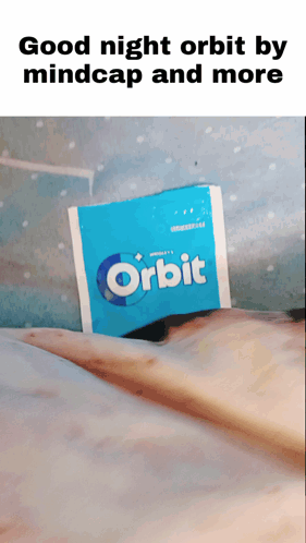 A Packet Of Orbit Gum Is Laying On A Bed GIF