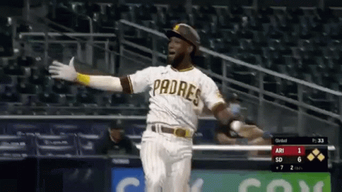 A Padres Baseball Player Is Running Towards Home Plate . GIF