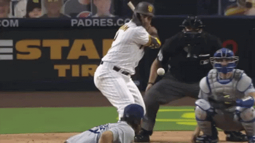 A Padres Baseball Player Is Swinging At A Ball GIF