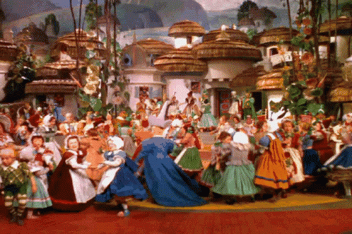 A Painting Of A Group Of People Dancing In Front Of A Village With Thatched Roofs GIF