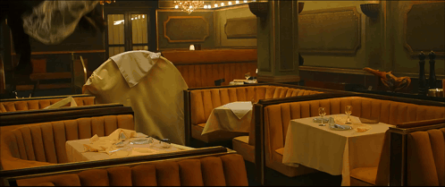 A Painting Of A Restaurant With Tables And Booths And A Few Birds Flying Around GIF