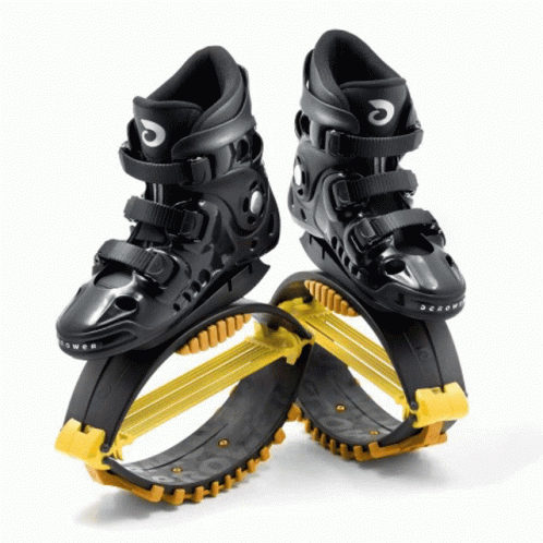 A Pair Of Black And Yellow Jumping Shoes With The Letter C On The Side GIF