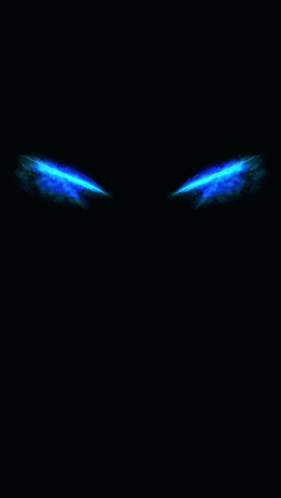 A Pair Of Blue Eyes Glowing In The Dark On A Black Background GIF
