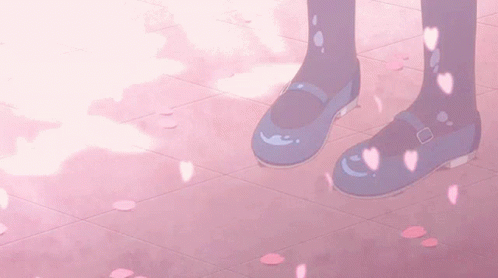 A Pair Of Blue Shoes On A Pink Tile Floor With Petals Falling From The Sky GIF
