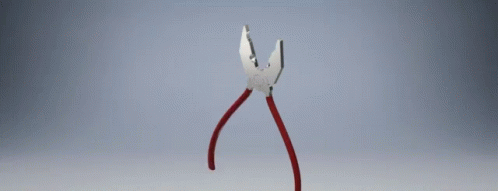 a pair of pliers with red handles on a gray surface