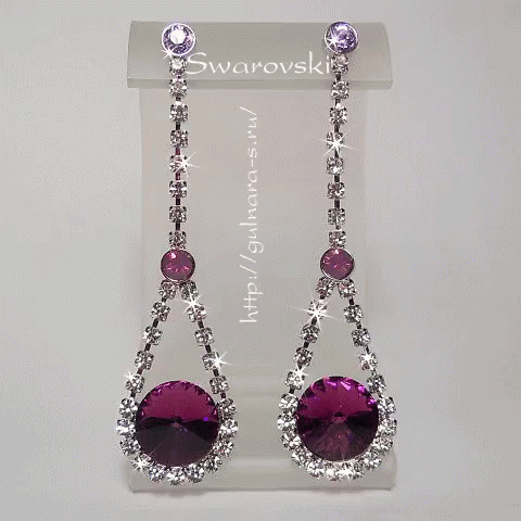 A Pair Of Purple And White Swarovski Earrings On Display GIF