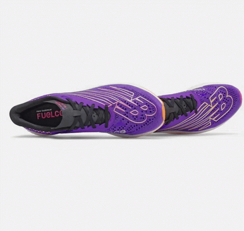 A Pair Of Purple New Balance Shoes On A White Surface GIF