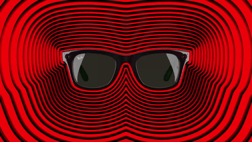 A Pair Of Ray-Ban Sunglasses Laying On A Red Surface GIF