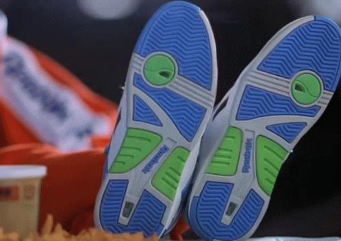 A Pair Of Reebok Shoes Are Laying On A Table GIF
