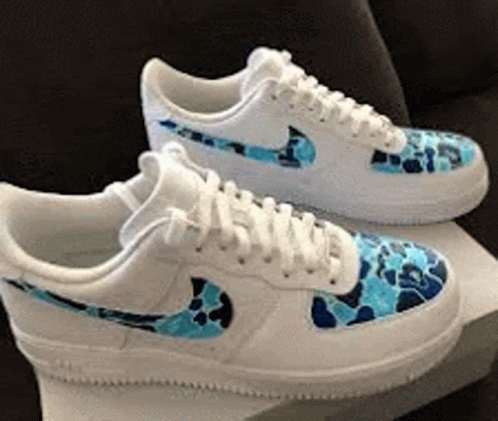 A Pair Of White Nike Air Force 1 Sneakers With A Blue Camo Pattern On Them GIF