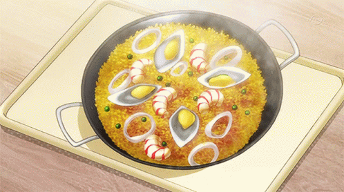 A Pan Filled With Rice And Seafood Is On A Table GIF