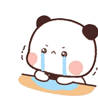 a panda bear is crying while sitting on a table .