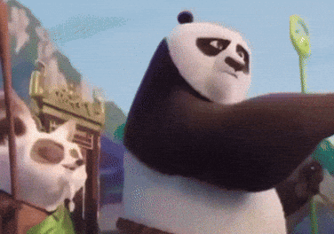 A Panda Bear Is Standing In Front Of A Castle GIF