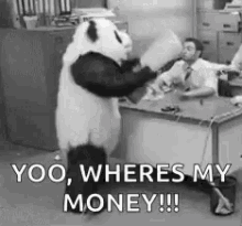 A Panda Bear Is Standing In Front Of A Desk In An Office Holding A Box . GIF