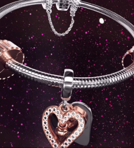 A Pandora Bracelet With A Heart Charm On It GIF