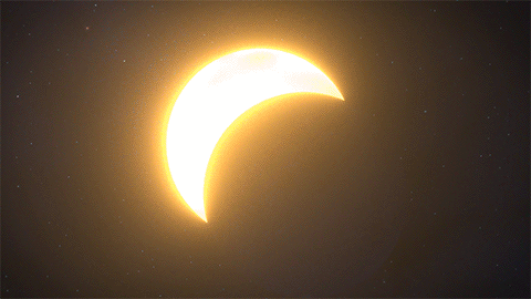A Partial Eclipse Of The Sun With A Crescent Moon In The Foreground GIF