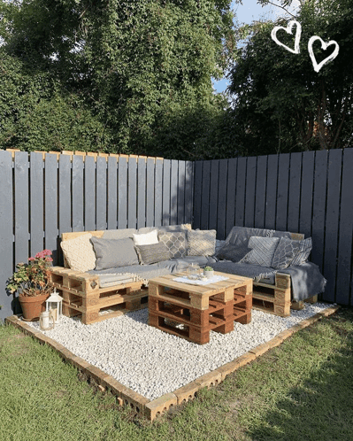 A Patio With A Couch And A Table Made Out Of Pallets GIF