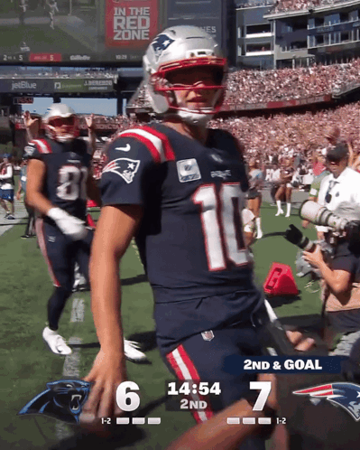 a patriots football player stands on the field during a game