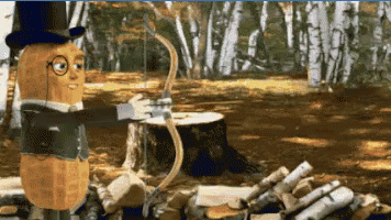 A Peanut In A Top Hat Is Holding A Bow And Arrow In A Forest GIF